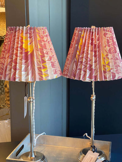 Pink and yellow marbled lampshades on silver lamps